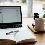 Image of laptop and opened book | How to Find and Connect With Your Ideal Clients