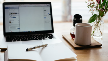 Image of laptop and opened book | How to Find and Connect With Your Ideal Clients