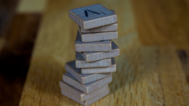 Image of stacked metal pieces on wood | The Minimal Marketing Stack for Coaches