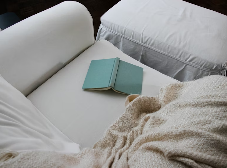 Image of a green book on couch | Why Doing Less Marketing Can Actually Create More Impact